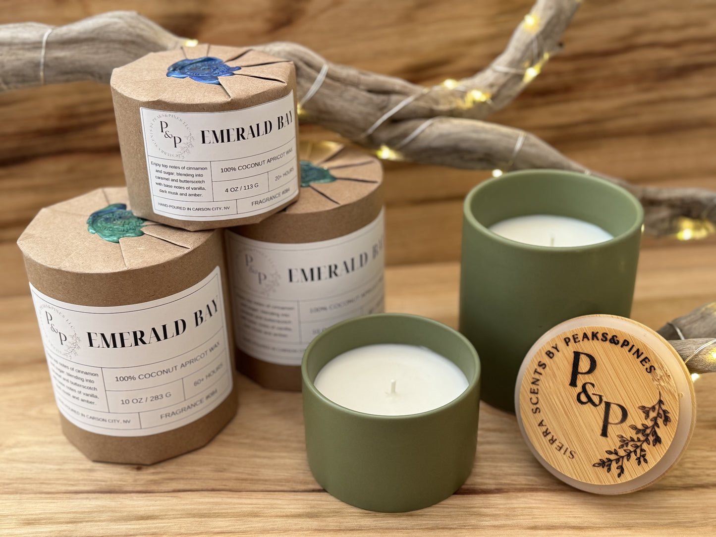 3 Emerald Bay 10 oz ceramic candles. 2 are wrapped and 1 is unwrapped showing the green vessel. 2 emerald bay 4oz ceramic candles one wrapped and the other unwrapped.