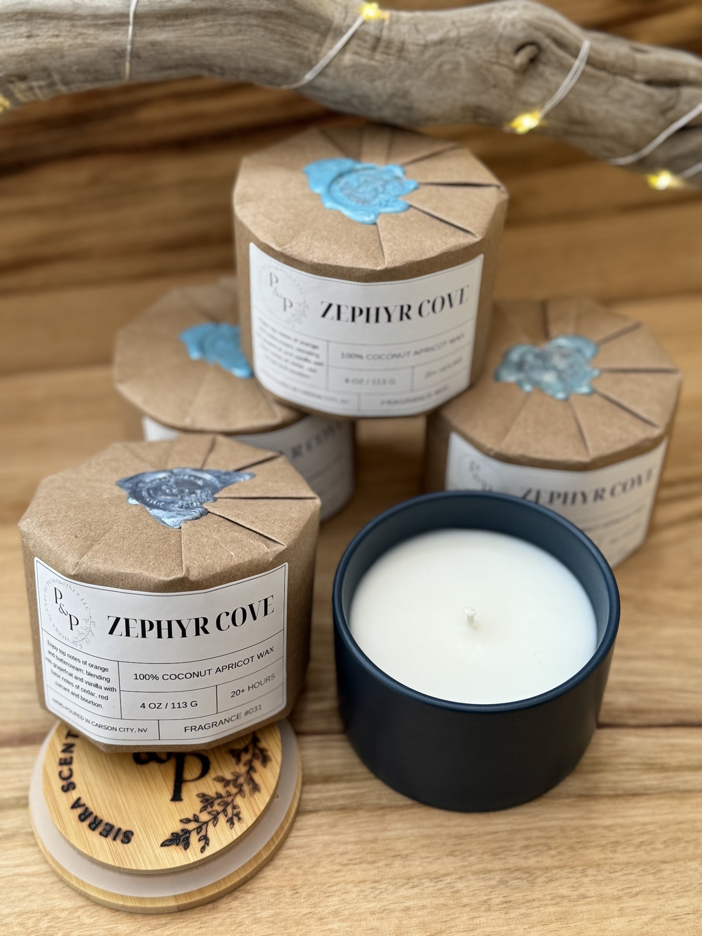  4 Wrapped Zephyr Cove 4 oz candles with wax seal, gift-ready packaging and 1
Zephyr Cove 4 oz candle unwrapped showing blue ceramic vessel and a branded wood lid.