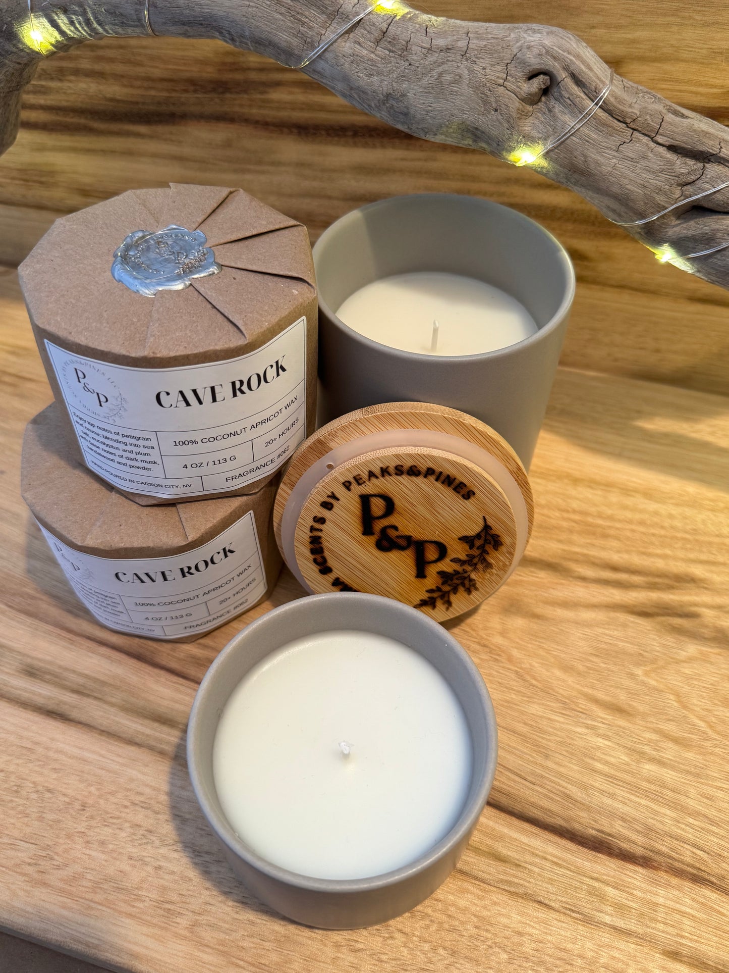 Cave Rock 4 oz and 10 oz ceramic candles displayed together, wrapped and unwrapped.