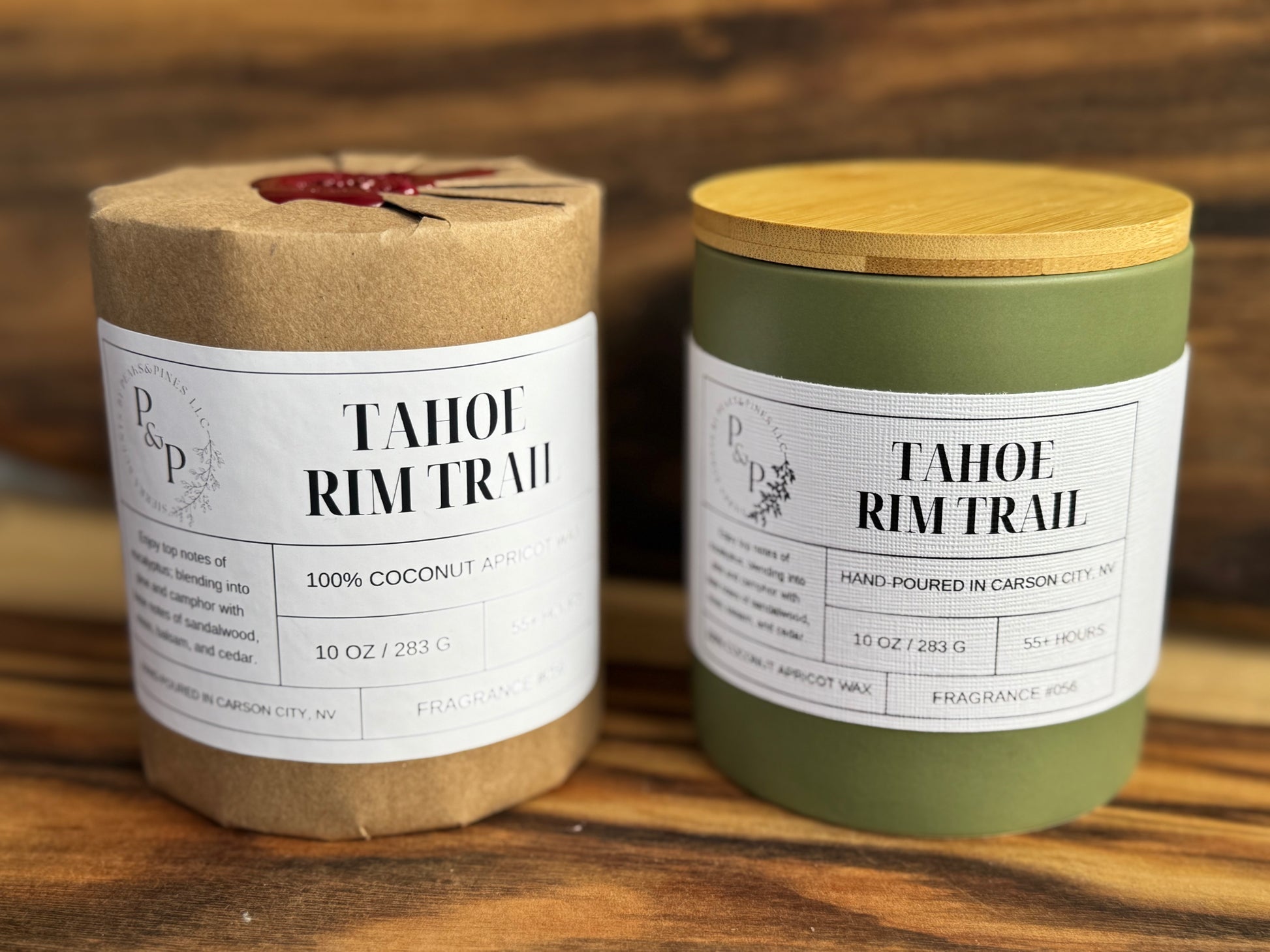 Two Tahoe Rim Trail 10 oz candles on a wooden surface, one wrapped in kraft paper with wax seal