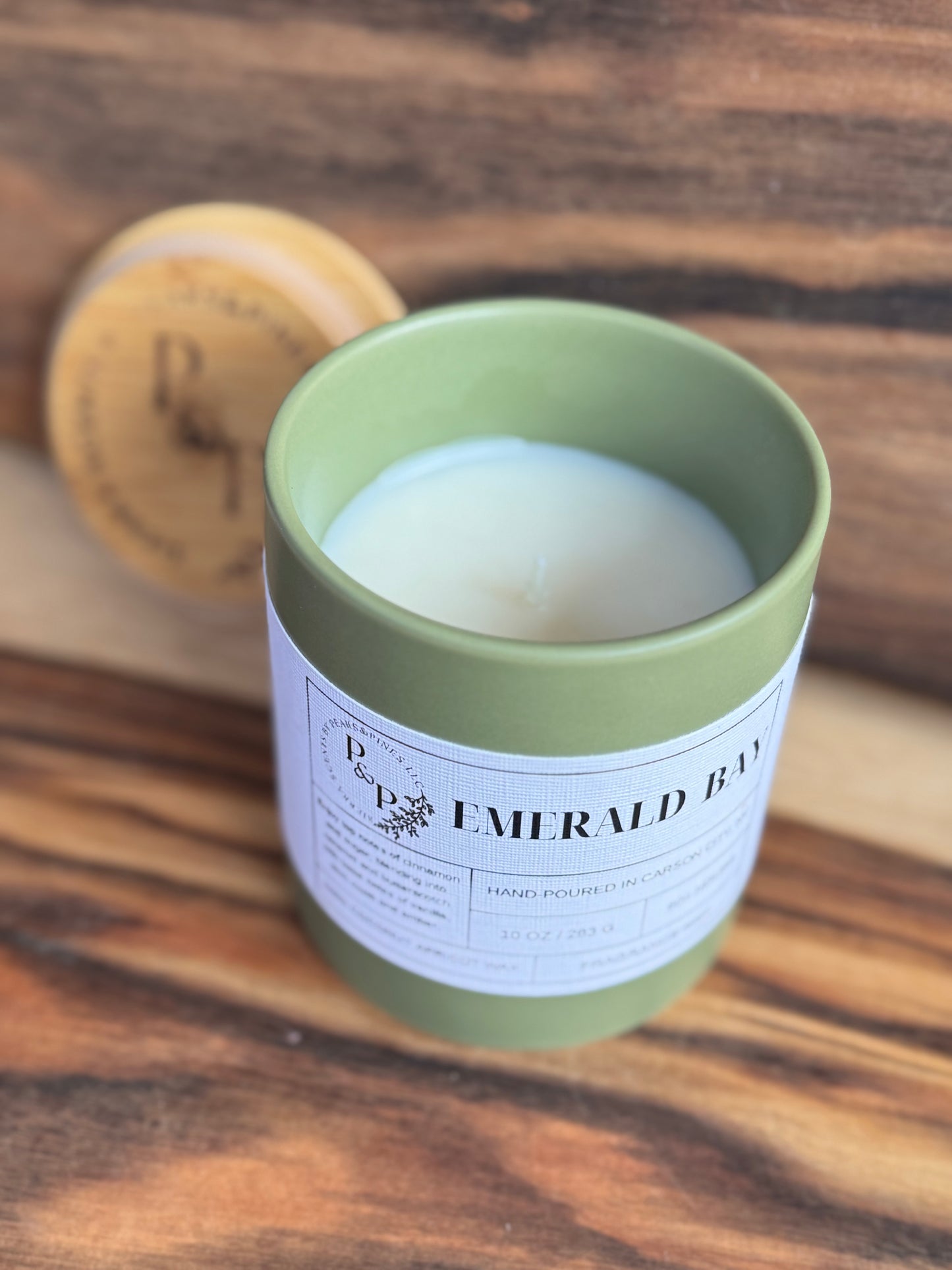 Emerald Bay 10 oz candle unwrapped showing ceramic jar and branded wood lid
