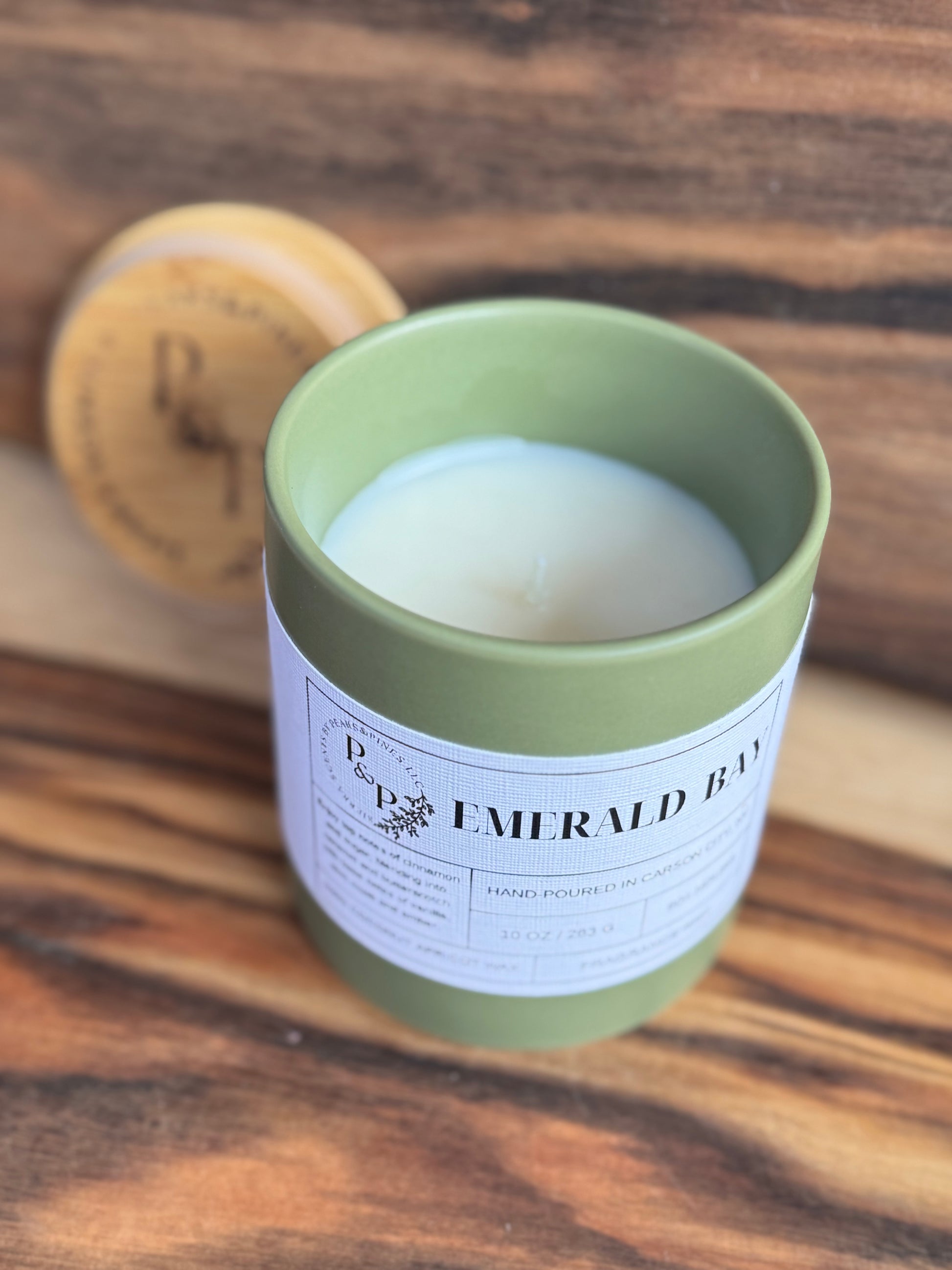 Emerald Bay 10 oz candle unwrapped showing ceramic jar and branded wood lid
