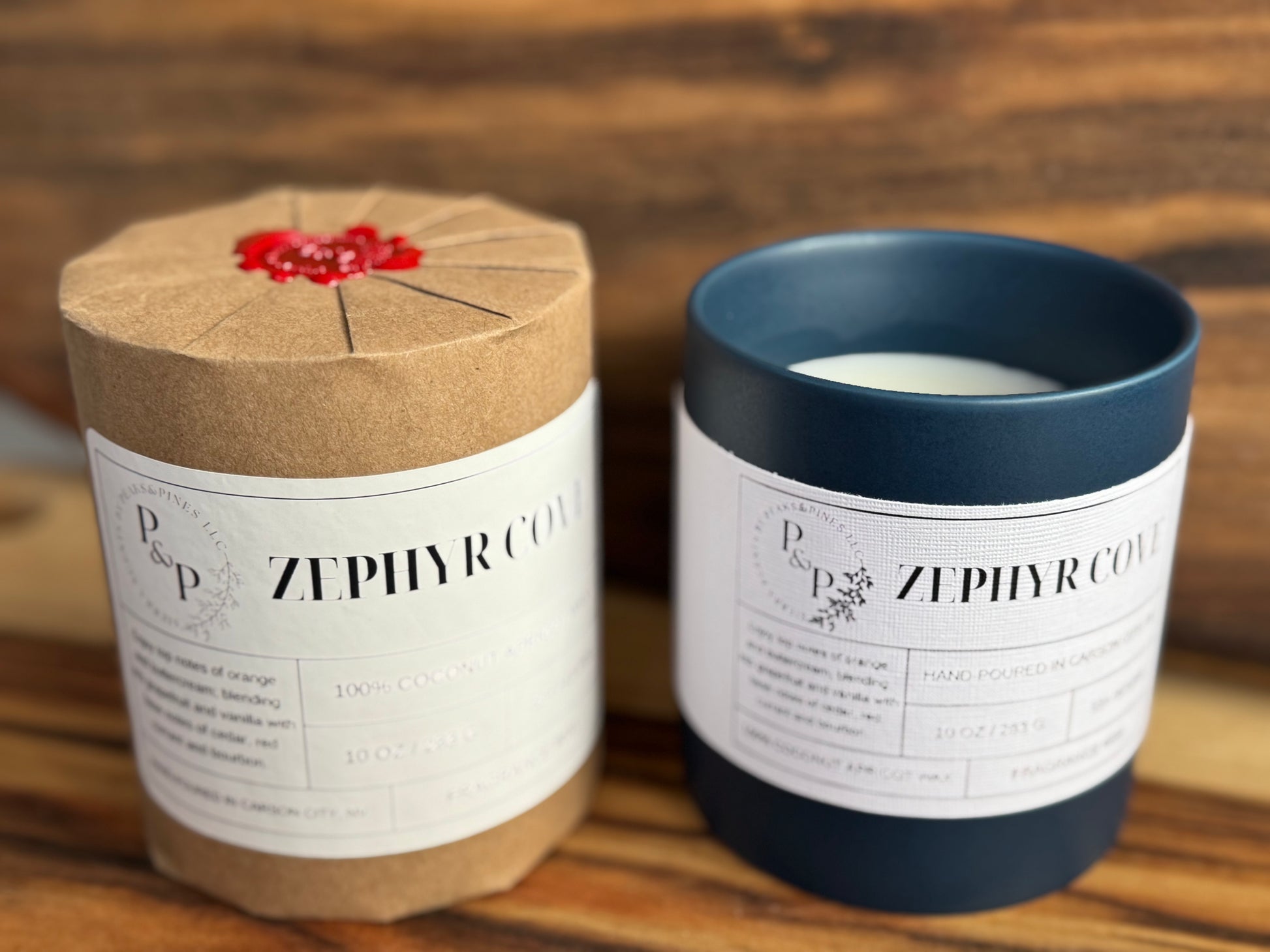 Two 10oz Zephyr cove candles.One wrapped and one showing blue ceramic vessel