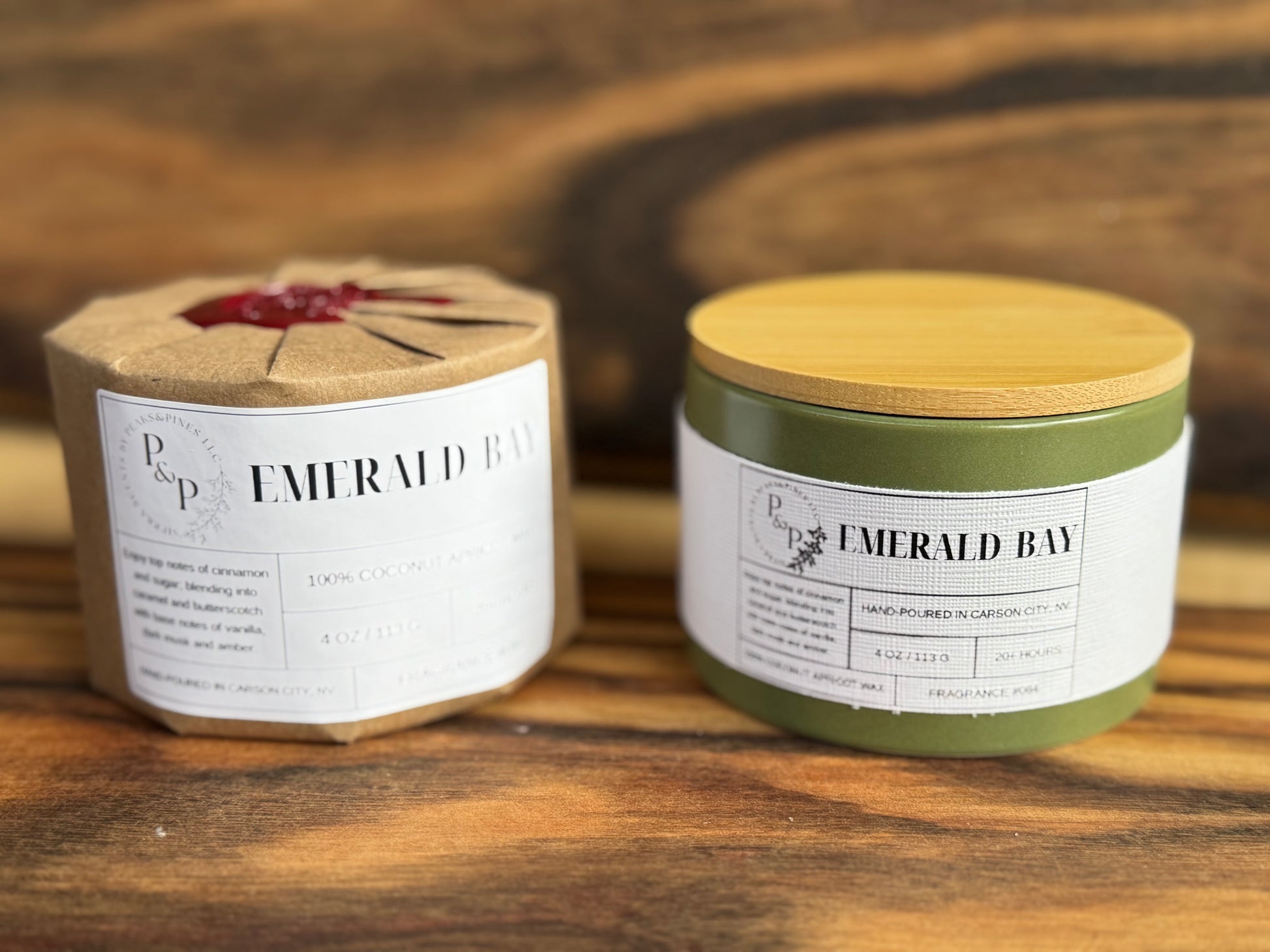 Two Emerald Bay 4 oz candles on a wooden surface, one wrapped in kraft paper with wax seal
