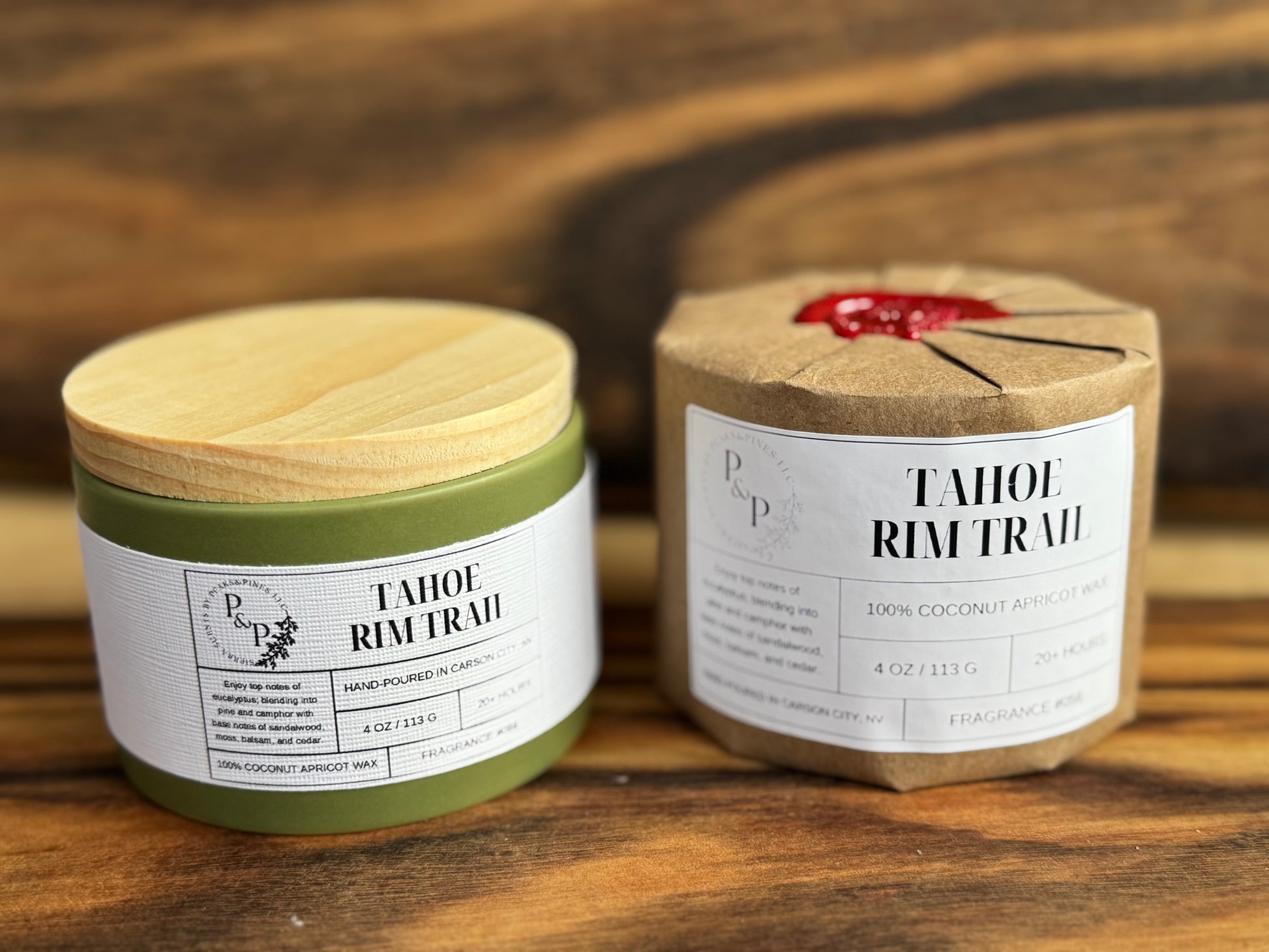 Two Tahoe Rim Trail 4 oz candles on a wooden surface, one wrapped in kraft paper with wax seal