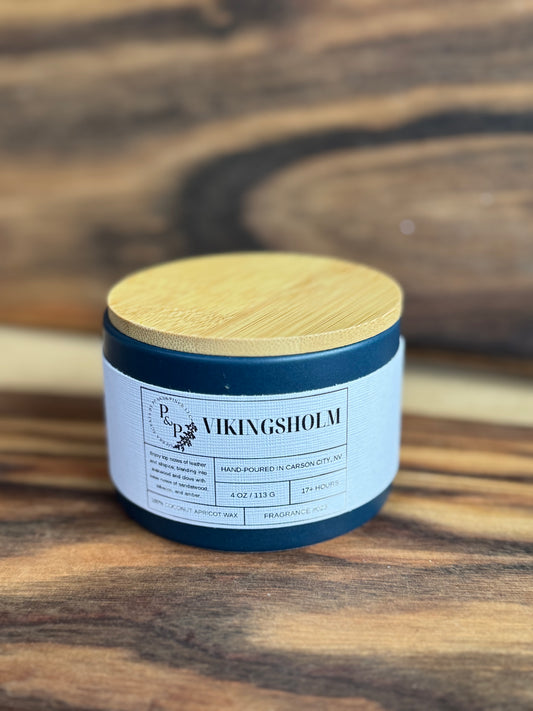 Vikingsholm 4 oz ceramic candle by Peaks and Pines, blue ceramic jar with wood lid and white label