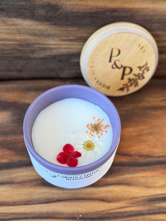 Carson Capitol Blossoms 4 oz ceramic candle by Peaks and Pines, botanical impressions line with pressed flowers in the wax and branded wood lid