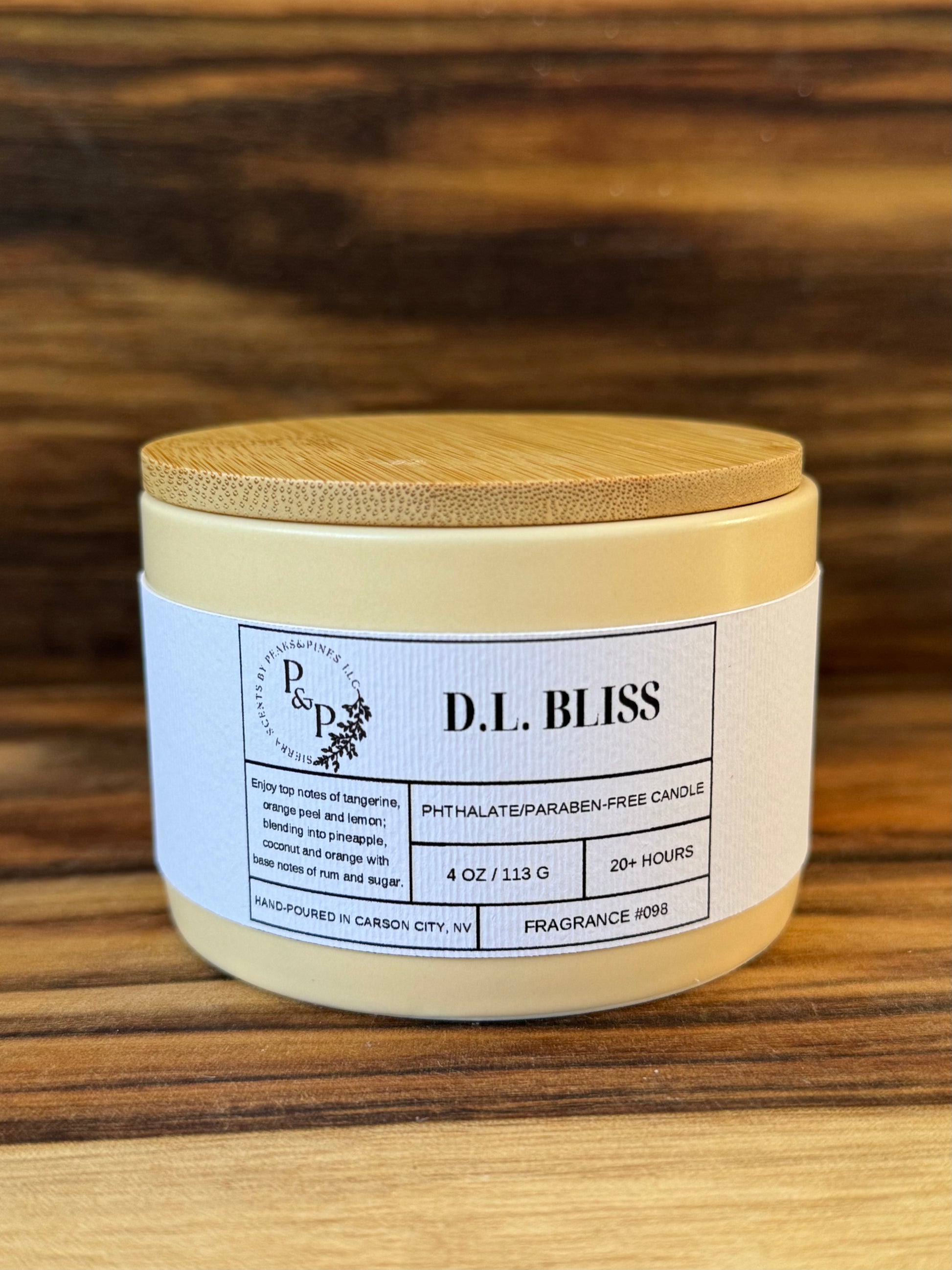 D.L. Bliss 4 oz ceramic candle by Peaks and Pines showing cream ceramic and white label