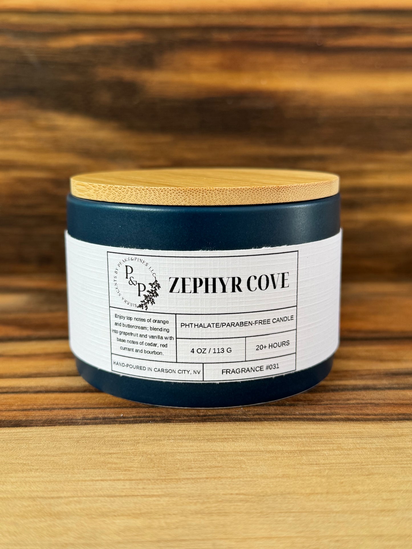 Zephyr Cove 4 oz ceramic candle by Peaks and Pines, blue jar with wood lid and white label