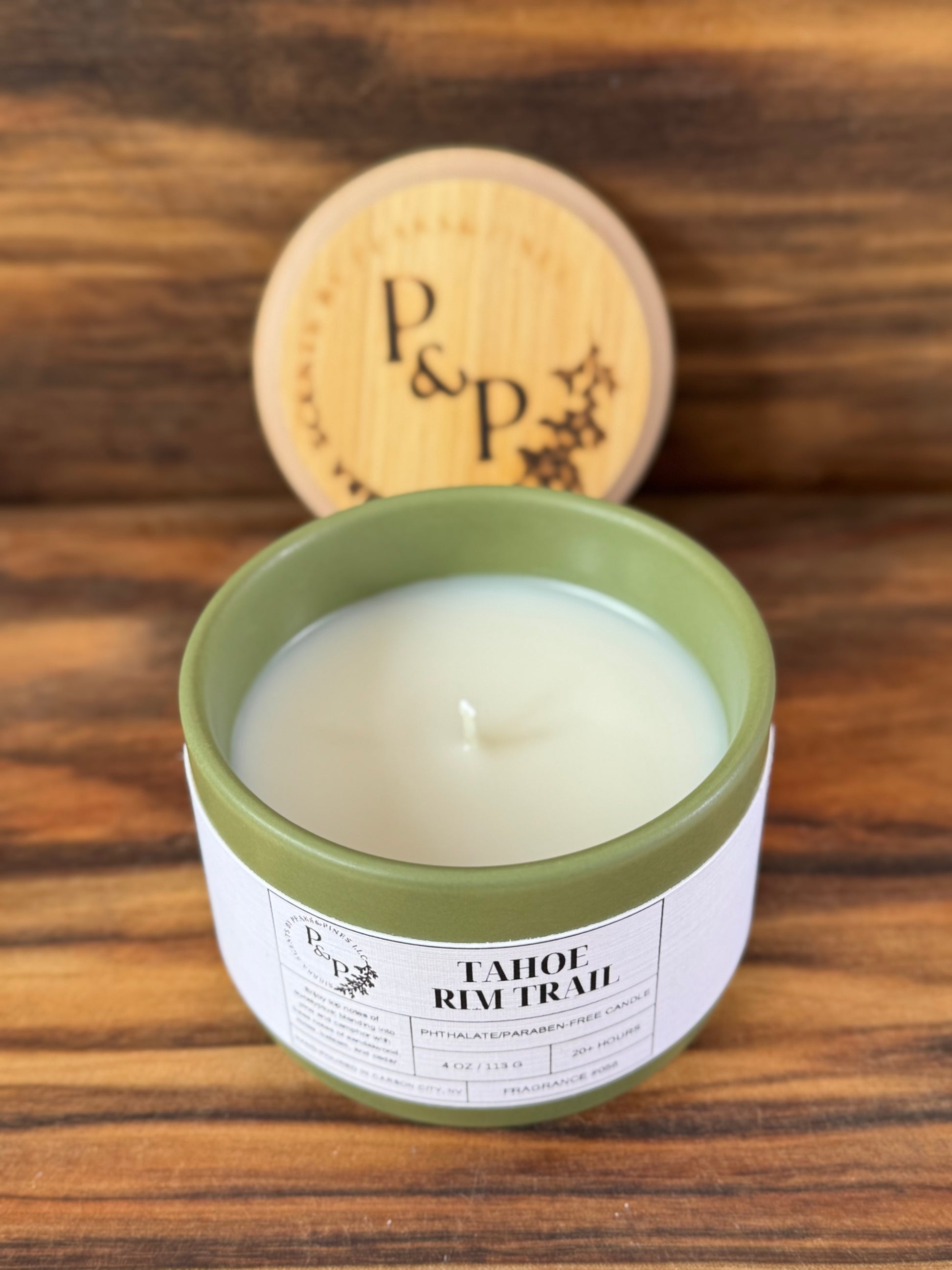 Tahoe Rim Trail 4 oz ceramic candle by Peaks and Pines, green ceramic jar with branded wood lid and white label.