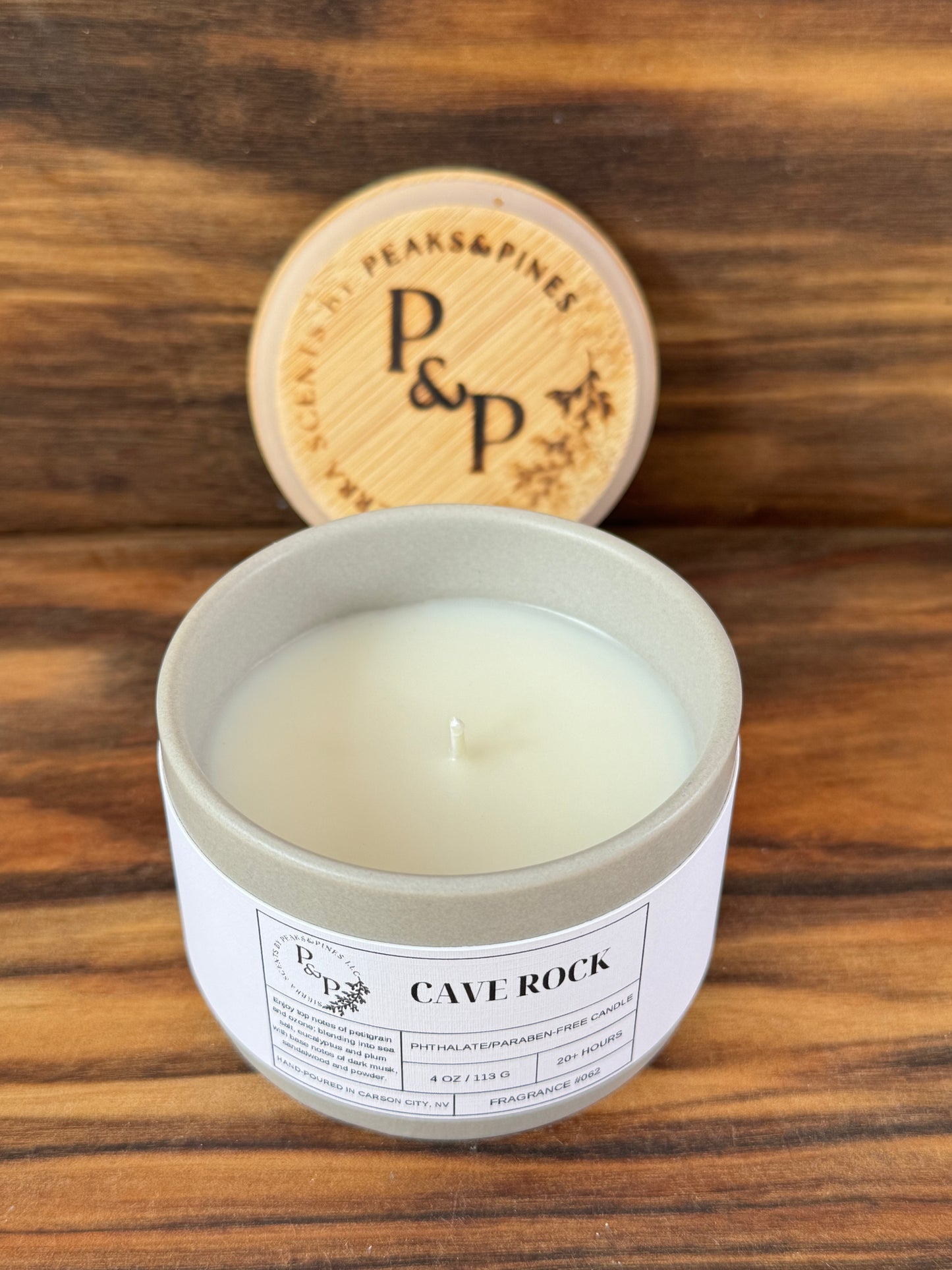 Cave Rock 4 oz ceramic candle by Peaks and Pines, grey ceramic jar with branded wood lid and white label