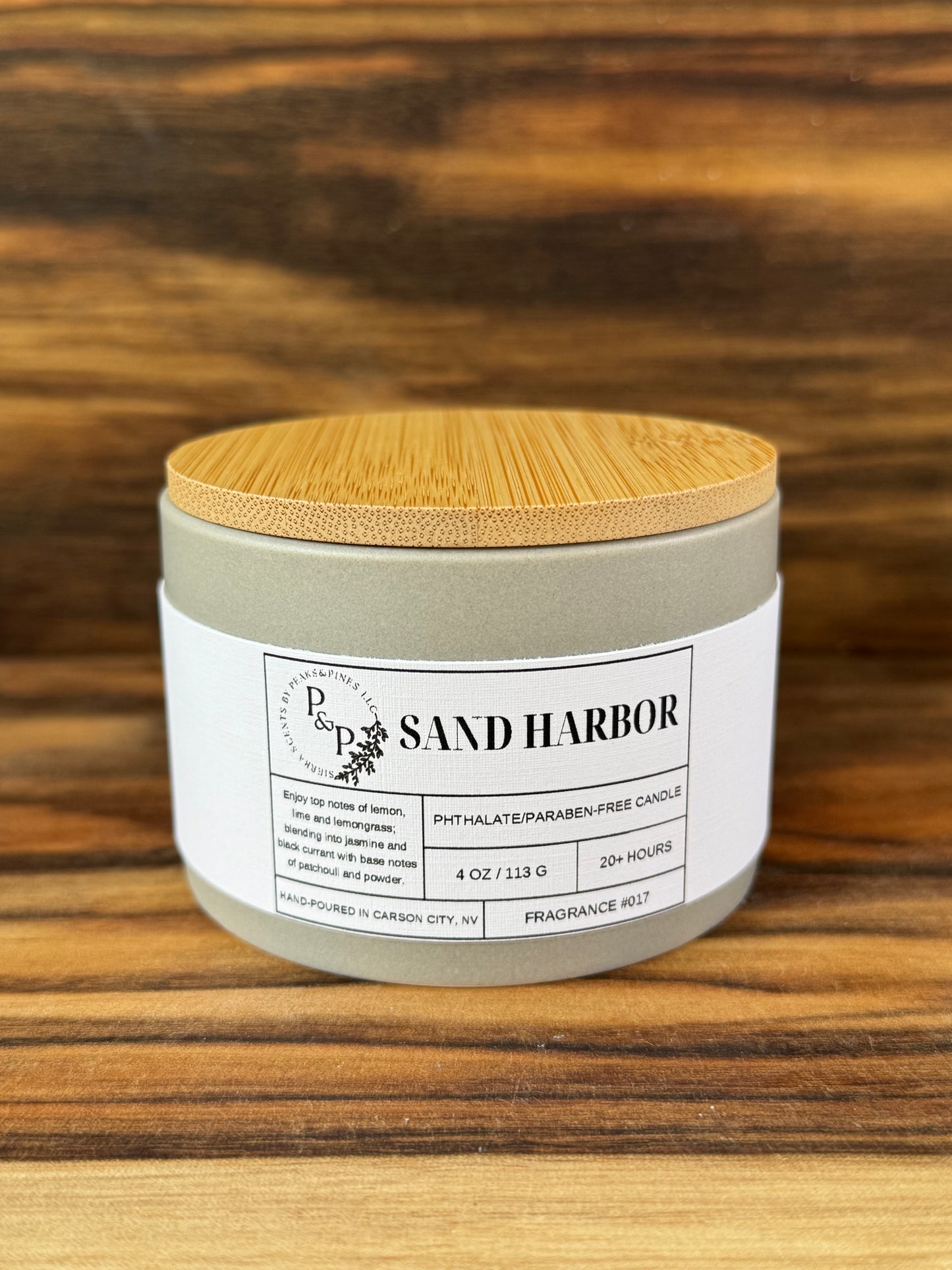Sand Harbor 4 oz ceramic candle by Peaks and Pines, gray jar with wood lid and white label