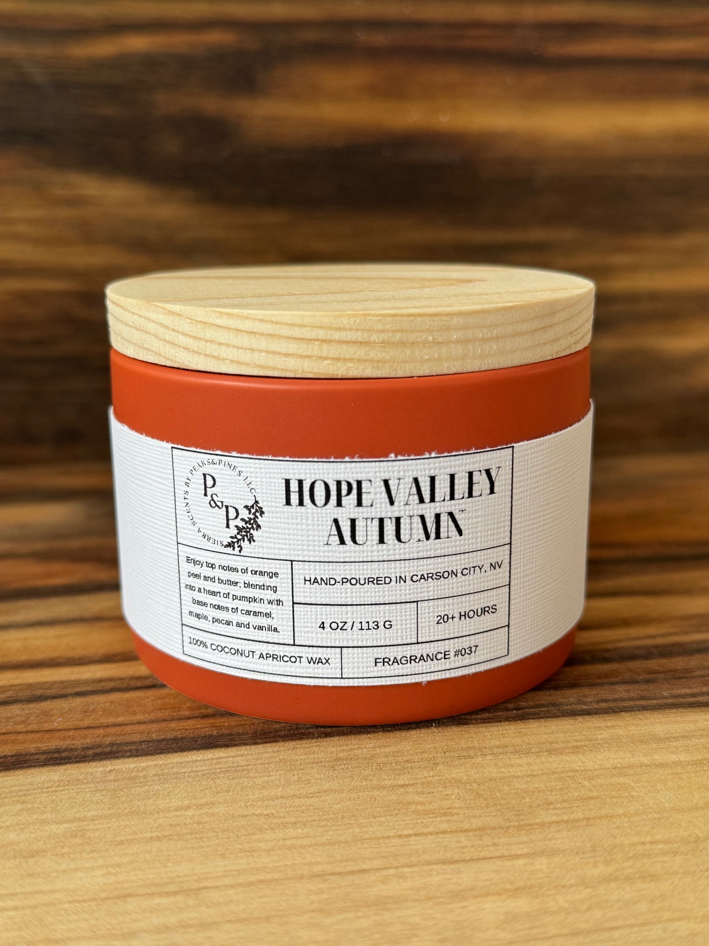 Hope Valley Autumn 4 oz ceramic candle by Peaks and Pines, orange ceramic jar with wood lid and white label