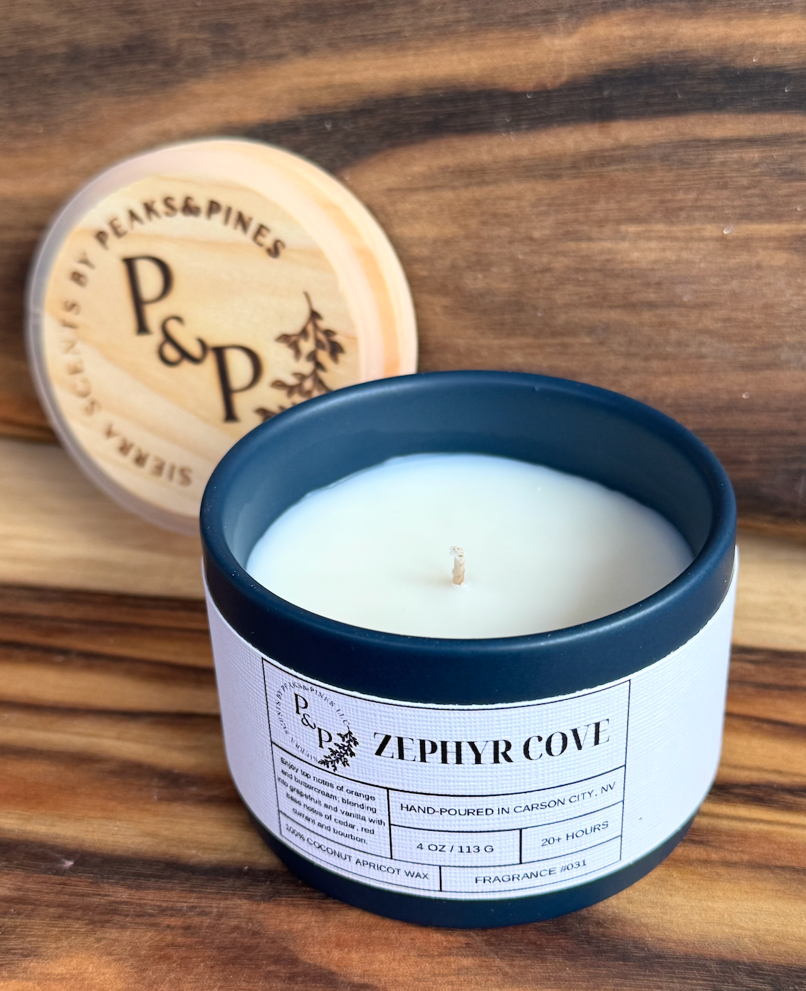 Zephyr Cove 4 oz ceramic candle by Peaks and Pines, blue jar with branded wood lid and white label